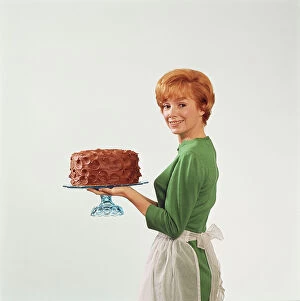 Casual Collection: Woman holding cake, smiling, portrait