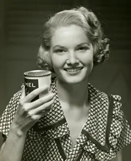 Woman holding can of food
