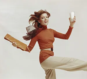 Casual Collection: Woman holding glass of milk and file, smiling, portrait