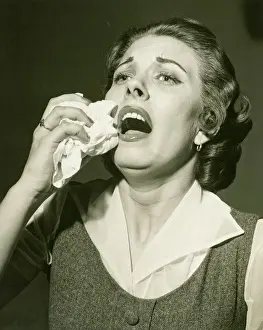 25 30 Years Prints: Woman holding handkerchief about to sneeze, (B&W), close-up