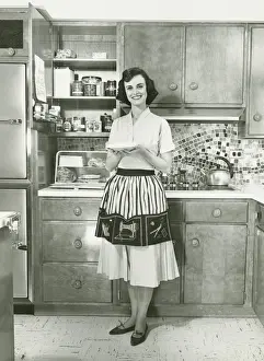 Series Prints: Woman holding pie, posing in kitchen, (B&W), portrait