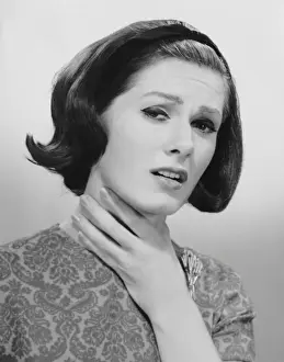 Woman holding her throat in pain