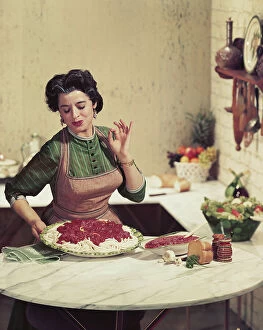Mid Adult Collection: Woman holding tray of noodles and gesturing