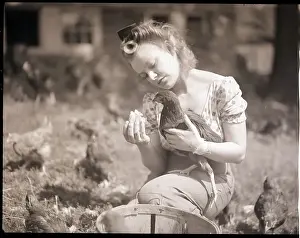 Woman Holds Chicken For Feeding