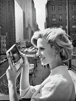 Compact Prints: Woman Holds Compact Sized Television