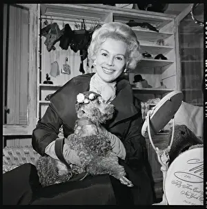Woman Holds Dog In Designer Outfit