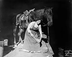 Horseshoe Prints: Woman Horse-Shoer Filing A Hoof