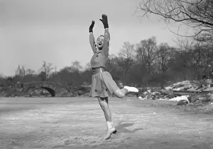 Woman ice skating outdoors, (B&W)