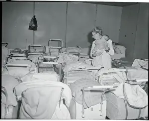 Woman with Infant Surrounded by Carriages