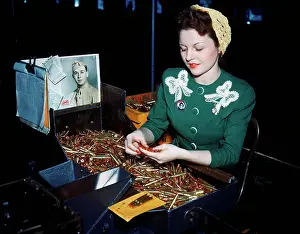 Sorting Prints: Woman Inspecting Bullets