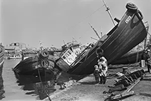 Earthquake Prints: Woman And Kids Look At Ship Upturned