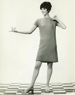 Images Dated 5th May 2006: Woman in knitted dress gesturing in studio, (B&W), portrait