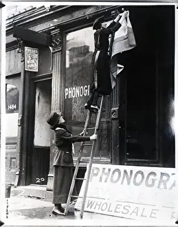 Headquarters Prints: Woman on Ladder Fixes Women's Party Sign