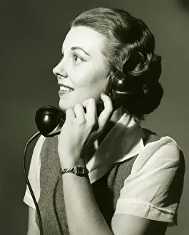 25 30 Years Prints: Woman on landline phone posing in studio, (B&W), portrait
