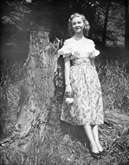 Sundress Prints: Woman leaning against tree trunk in forest, (B&W), (Portrait)