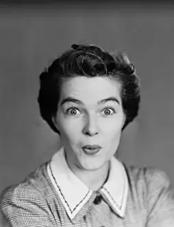 One Mid Adult Woman Only Prints: Woman with lips pursed and eyes wide open, portrait