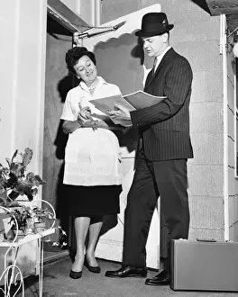 Woman listening to salesman in doorway