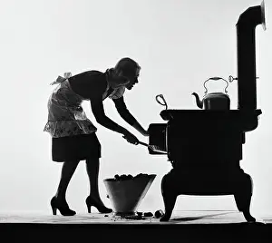 Filling Prints: Woman Loading Stove With Coal