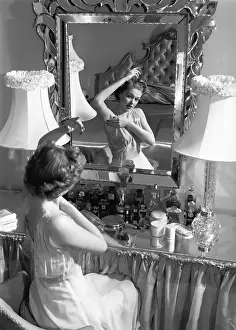 20 25 Years Prints: Woman looking in mirror, checking underarms (B&W)
