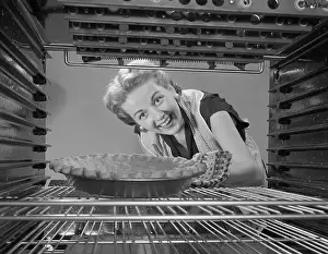 Convenience Prints: Woman Looking at Pie in Oven