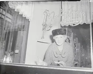 Woman Looking Through Store Window