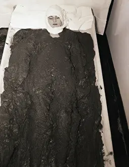 Woman Lying in Mud Bath