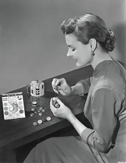 Woman Making Buttons with Kit