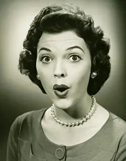 Neat Prints: Woman making face in studio, (B&W), close-up, portrait