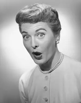 Woman making face in studio, (B&W), portrait