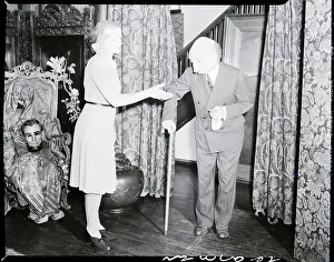 Benda Prints: Woman in Mask Lends Hand to Man in Mask