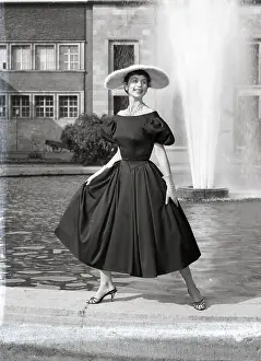 Dusseldorf Prints: Woman Modelling Dress & Hat At Fountain