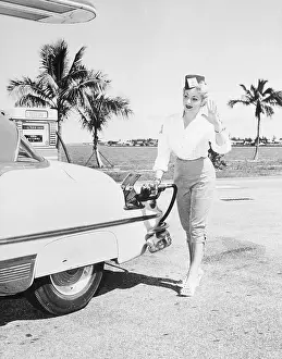 Woman Operating Gas Pump on Broad Causeway, Miami