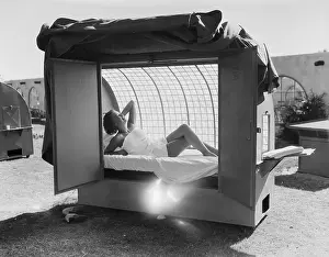 Sunbathing Prints: Woman in Outdoor Tanning Booth