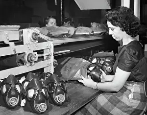 Gas Mask Prints: Woman Packing Assembled Rubber Gas Masks