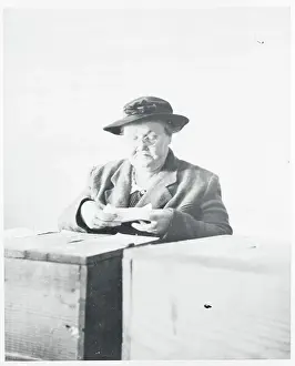 Woman Pausing at Ballot Box While Voting
