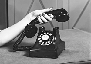 Images Dated 6th November 2006: Woman picking up phone, (close up of hand), (B&W)
