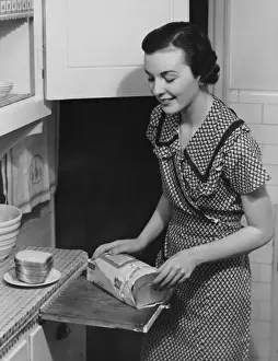 Woman placing bread on plate