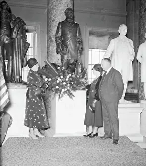 Woman Placing Wreath at Statue