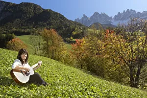 Images Dated 20th October 2012: Woman playing guitar in the mountains