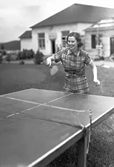 Weekend Activities Prints: Woman playing table tennis in garden, (B&W)