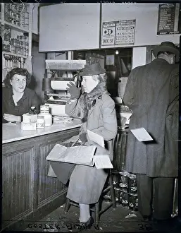 Clerk Prints: Woman Points Ration Book At Store Clerk