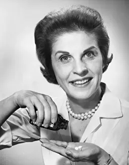 Woman pouring pills from bottle