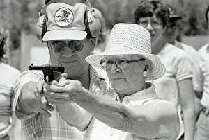 Woman Practicing Firing a Gun