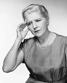 Grief Prints: Woman pressing forehead with fingertips