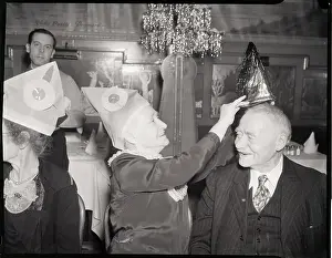 Retirement Prints: Woman Puts Hat On Man In Banquet Hall