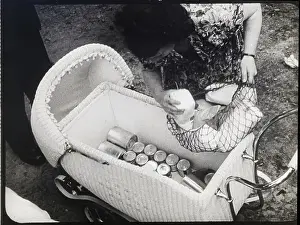Woman Puts Netted Basket Into Baby Carri