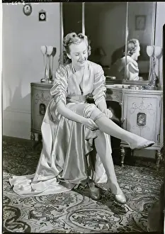Woman Putting On Stockings