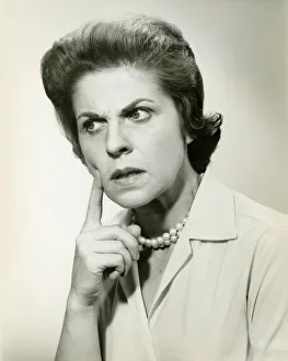 Pearl Collection: Woman with puzzled expression, in studio, (B&W), portrait