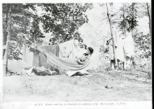 Woman Reading in Hammock During Camping Trip