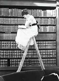 Library Prints: Woman Reading on Top of Ladder